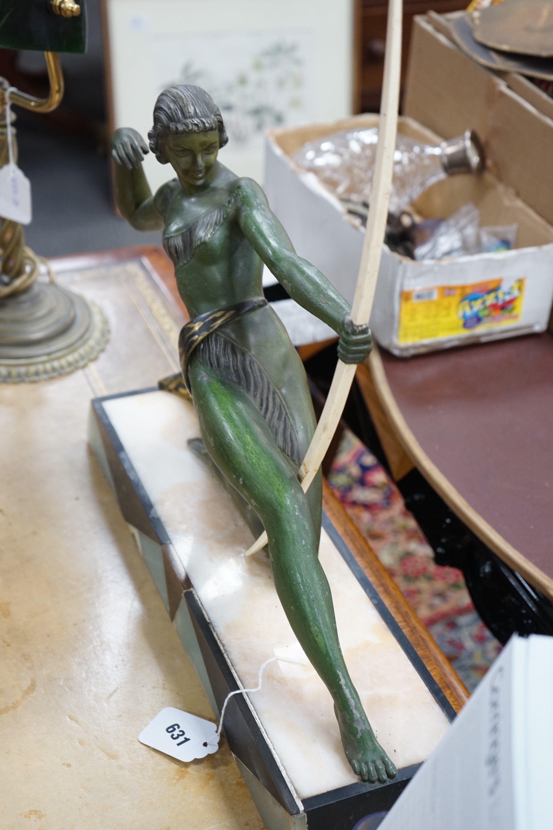 A French Art Deco spelter bronzed model of Diana The Huntress, with ornate marble base, after Uriano. 49cm wide